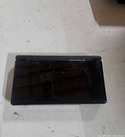 Closed top view of black Nintendo DS Lite