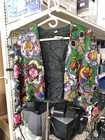 Full view of one ornate sequin jacket on hanger