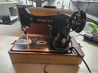 Full view of Singer Model 99 on wood base with cover removed