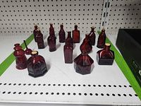 All 16 ruby red miniature bottles on shelf