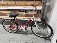 Full left side view of red and white Schwinn Cruiser Six bicycle