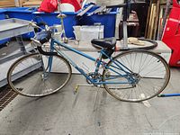 Full side view of blue Schwinn Traveler bicycle showing overall condition