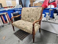 Front view of upholstered settee showing palm motif fabric and dimensions