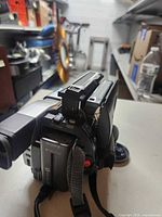 Rear and side view of Sony Handycam camcorder showing battery and strap