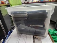 Side view of translucent tote filled with stacked DVD cases