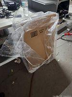 Shrink-wrapped bundle of flat cardboard boxes