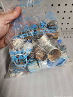 Front view of sealed bag showing mixture of tube sockets, metal sleeves and components