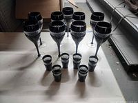 Group of nine goblets and six shot glasses on table