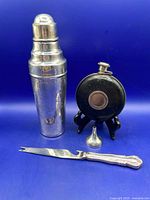 Cocktail shaker, hip flask on stand, funnel, bottle opener/cheese knife displayed