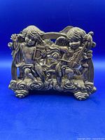 Front view showing two cherubs with instruments on cloud base