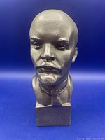 Front view of metal bust of Lenin on plinth