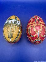 Both tin egg boxes top view showing colors and patterns