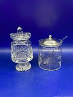 Both jam jars side by side; spoon visible in etched jar