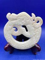 Front view of nephrite jade disk on stand