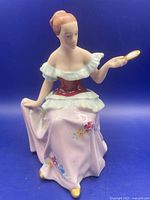 Front view of Royal Dux figurine showing details, mirror, floral skirt