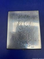 Closed sterling silver cigarette case with engraved cartouche and monogram