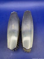 Two sterling silver clothes brushes top view