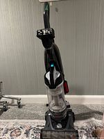 Front view of Bissell upright vacuum cleaner showing overall condition, hose and attached tools
