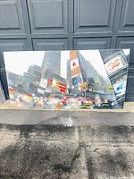 Full view of large cityscape canvas leaning on wall