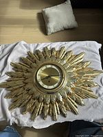 Full view of gilded sunburst wall clock front