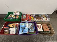 Five containers holding assorted books; variety of visible titles