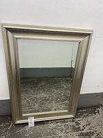 Front view of rectangular silver framed mirror