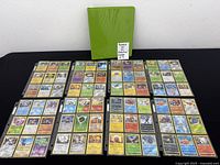 Binder closed and eight sheets of cards laid out