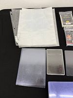 Sealed packs of card sleeves, binder pages, top loaders assortment