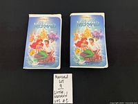 Front view of two The Little Mermaid clamshell VHS cases side by side