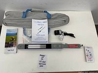 All components laid out: wand, case, manuals, adapter