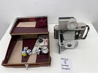 Overall view of Polaroid camera with flash, case and accessories