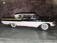 Driver side view of the pink and black 1957 Mercury Turnpike Cruiser diecast