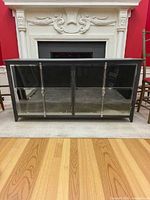Front view of charcoal wood sideboard with four mirrored panels and nickel hardware
