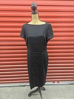 Full front view of black sheath dress on mannequin