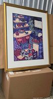 Framed print angled on box to show artwork, mat, and frame