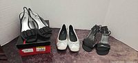 All three pairs of shoes side by side with box