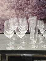 Group of wine glasses and champagne flutes on surface