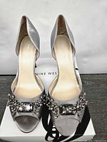 Front view of both satin heels showing crystal embellishment