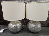 Front view of both lamps showing shades and silver mercury glass bases