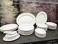 Full set showing stacks of plates, platters, and gravy boat