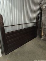 Headboard and footboard leaning against wall