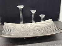 Tray with three glass candle holders displayed