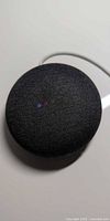 Top view of charcoal Google Home Mini showing status LEDs