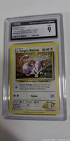 Front view of CGC slab showing holo Lt. Surge's Rattata card and CGC grade 9 label