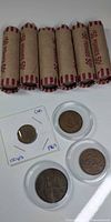 Six wrapped penny rolls and four encapsulated coins overview