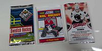 Front view of all three sealed hockey card packs