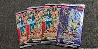 Front view of four sealed Yusei 3 Duelist Packs