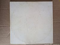 Front of white gatefold sleeve with embossed title