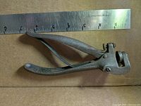 Full view of saw set pliers with ruler for scale