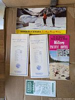 Selection showing Alberta-Canada brochure, Lake Louise trails booklets, Millers Pacific Hotel brochure, Perry map coupon